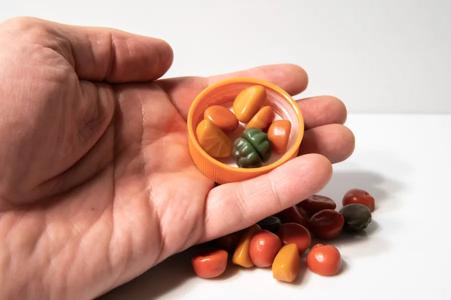 Hand holding multivitamin gummies